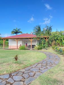 a house with a stone path in front of it at Le Royal Horizon in Deshaies