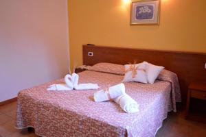 Postel nebo postele na pokoji v ubytování Desusino Residence & Hotel