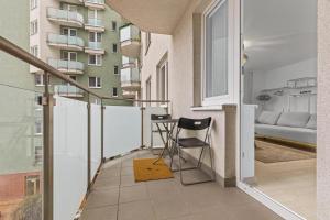 a balcony with a bar stool in a apartment at AH Bosakova Elegant in Bratislava