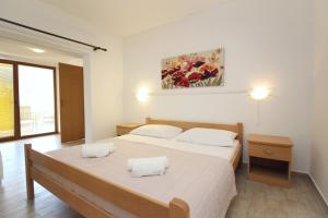 a bedroom with a bed with two white pillows at Apartments Petrica in Baška