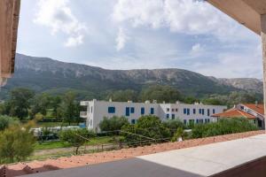 a view from the roof of a house with mountains in the background at Apartments Petrica in Baška