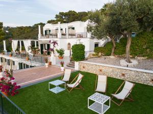 a view of a house with a lawn and chairs at Amira Resort in Anacapri