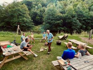 a group of people sitting around a picnic table at Camp Kyllburg in Kyllburg