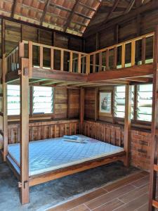 a bedroom with two bunk beds in a room at Adventure Cottage in Gopeng