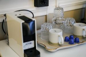 a toaster sitting on a counter with cups and glasses at Leila Mansion Hotel in Tekirdağ