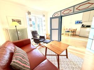 a living room with a couch and a table at Gartenwohnung in Nieblum +8 photos