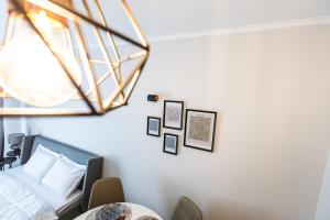 a bedroom with a bed and some pictures on the wall at Bella Mare Boutique apartment in Sunny Beach