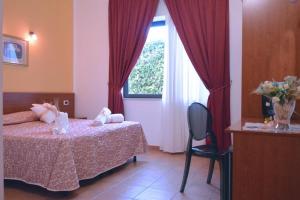 Postel nebo postele na pokoji v ubytování Desusino Residence & Hotel