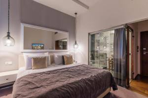 a bedroom with a large bed with a large mirror at Wellness & spa hotel Augustiniánský dům in Luhačovice