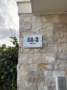 a clock on the side of a stone wall at La Tranquillità in Draçi +5 photos