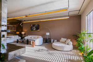 a living room with two white couches and a couch at Portal Chalets With Private Pool - Al-Rawda in Riyadh