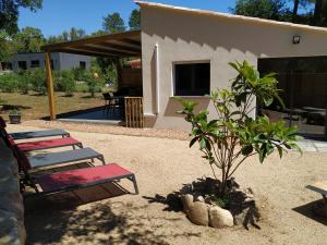 a patio with two lounge chairs and a small tree at L'Attellu di Babbu in Lecci