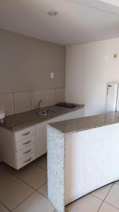 a kitchen with a counter top and a refrigerator at REDE APARTHOTEL Praia Mansa in Fortaleza
