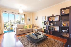 a living room with a couch and a coffee table at Charming Garajau by AH in Caniço