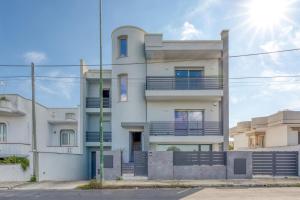a white building with balconies on the side of it at Stanza doppia vicino ospedale di Tricase - Palazzo Credaro in Tutino
