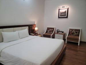 Voodi või voodid majutusasutuse Luxor Boutique Hotel toas