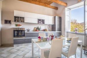 a dining room with a table and chairs and a kitchen at Apartment Caruso in Sorrento +17 photos