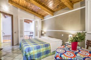 a bedroom with a bed and a table in a room at Apartment Caruso in Sorrento