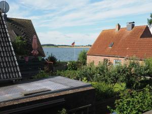a view of the water from the roof of a house at Ferienwohnung mit Balkon und Schleiblick in Maasholm