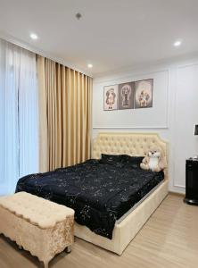 a bedroom with a large bed with a teddy bear on it at 1 bedroom - Apartments in luxury in Gia Lâm Pho