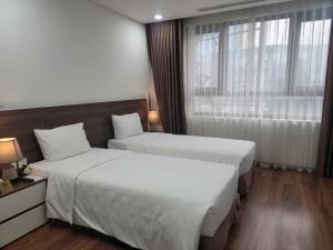 Voodi või voodid majutusasutuse Luxor Boutique Hotel toas