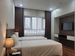 Voodi või voodid majutusasutuse Luxor Boutique Hotel toas
