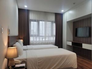 Voodi või voodid majutusasutuse Luxor Boutique Hotel toas