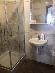 a bathroom with a sink and a shower at Tonka Apartments in Zadar +99 photos