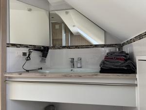 a bathroom with a sink and a mirror at Semihome in Dietingen +6 photos
