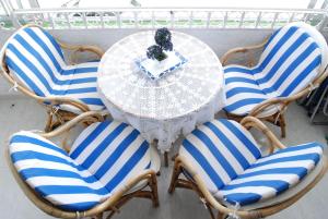 a table with blue and white chairs and a table with at Carabeo 15 Studios Casasol in Nerja