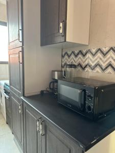 a microwave on a counter in a kitchen at AMS Global in Accra