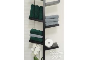 a bathroom with a black towel rack with green towels at Yoolim stay # 건대입구# 성수# 잠실롯데타워 in Seoul +39 photos