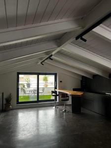 an empty room with a table and a large window at Zora loft&essence in Manfredonia