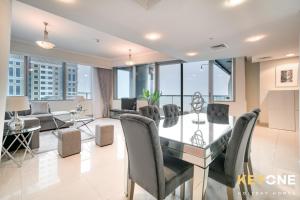 a dining room and living room with a glass table and chairs at Captivating Sky & Sea Views in Two Bedroom Suite in Dubai