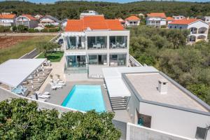 an aerial view of a house with a swimming pool at Villa Lalic Gallery - Adriatic Luxury Villas in Bibinje