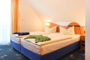 Postel nebo postele na pokoji v ubytování Aparthotel Leuchtfeuer Rügen