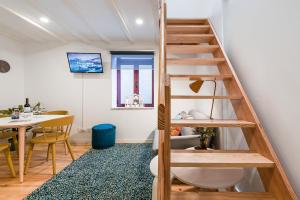 a room with a staircase and a dining room with a table at GuestReady - Easygoing Pool to River in Bandeira