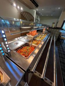 a buffet line with many different types of food at Bowood Park Hotel in Camelford