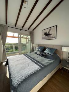 a bedroom with a large bed and a large window at Breath taking seaview Apartment at Lighthouse Beach in Paphos City