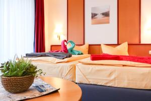 Postel nebo postele na pokoji v ubytování Aparthotel Leuchtfeuer Rügen