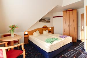 Postel nebo postele na pokoji v ubytování Aparthotel Leuchtfeuer Rügen