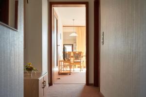 a hallway leading to a dining room with a table at Pension Kueck in Büsum