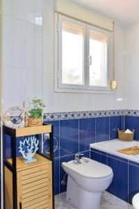 a blue and white bathroom with a toilet and a sink at Esmeralda HOME JÁVEA in Jávea +18 photos