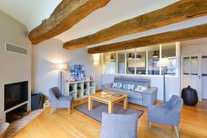 a living room with a couch and a table and chairs at Manoir de Larmor in Vannes +40 photos