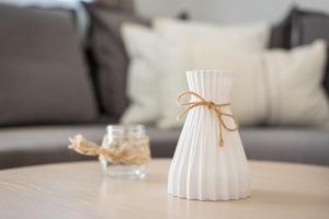 a white vase with a bow on a table at Costa Calma Rio Barca Beach in Costa Calma