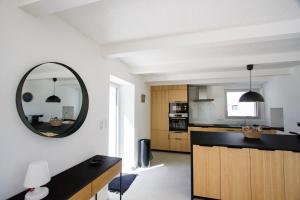 a kitchen with a mirror on the wall at Tipoz'Immo Ti Marin beach accessrestaurants on foot in Plovan