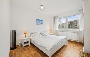a white bedroom with a bed and a window at 1 Bedroom Nice Apartment In Anklam in Anklam