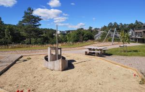 a park with a picnic table and a bench at 4 Bedroom Stunning Home In Søgne in Søgne
