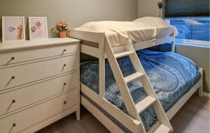 a bedroom with a bunk bed and a dresser at 4 Bedroom Stunning Home In Søgne in Søgne