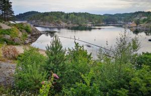 a view of a river with a fishing pole in it at 4 Bedroom Stunning Home In Søgne in Søgne